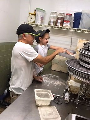 Making pizza in the kitchen at Joe's Pizza